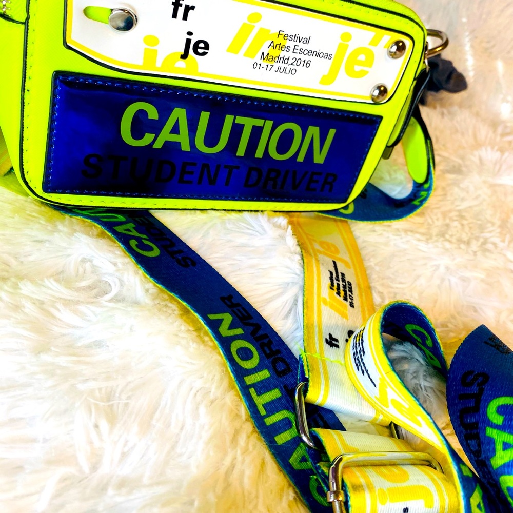 Caution crossbody shoulder bag with guitar strap.